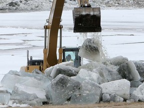 Crews break ice on the Red River Floodway near the St. Mary's Road bridge. The city says opening the floodway has prevented flooding in 100 homes already since the gates opened Wednesday. (MARCEL CRETAIN/SUN MEDIA)