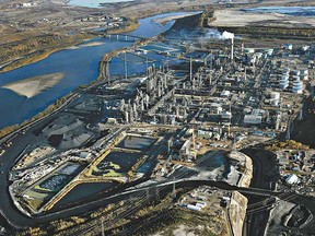 The economy shark in August largely due to decreased production in the natural resources sectors - oil and gas extraction and mining - as well as in manufacturing, Statistics Canada said in a report on Wednesday. Pictured here are Canada's oilsands. (QMI Agency/Pascal Ratthe)