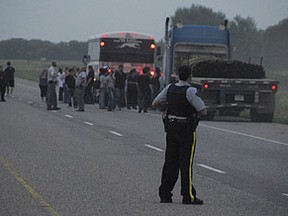 In this 2008 photo, witnesses and passengers from a second Greyhound bus were interviewed by Manitoba RCMP members while other Mounties stood guard at the scene of Vince Li's decapitation killing of Tim McLean. Less than five years later, Li is taking steps towards his release from Selkirk Mental Health Centre. (ROB SWYSTUN, Sun Media)