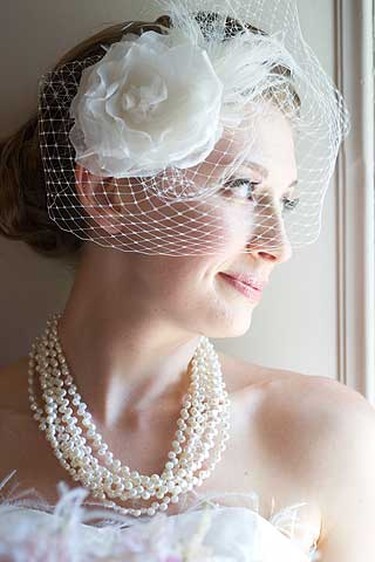 Brides will fancy veils, vintage hats and headpieces to add a dramatic look. Above, a birdcage bridal veil from LaKrause Headwear. (Supplied)