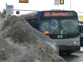 Feb. 4: A bus stop sign is surrounded by a huge windrow on the corner of 149 St. and 82 Avenue in Edmonton. (LAURA PEDERSEN/EDMONTON SUN)