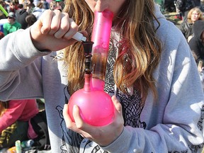A male lights up a bong during the 4-20 celebrations at the Manitoba Legislature in Winnipeg Wednesday, April 20, 2011.