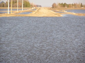 This RM of Morris road is closed because of flood water flowing through the Morris River Diversion near Rosenort on April 25, 2011.