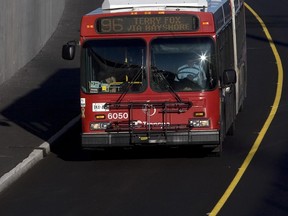 An OC Transpo bus rolls down the Transitway headed west from Pinecrest to Bayshore. (DARREN BROWN/Sun Media)