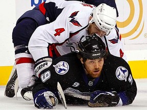 Tampa Bay Lightning's Steve Downie (bottom) battles for a loose puck with Washington Capitals' John Erskine during the first period of Game 3 of their Eastern Conference Semifinal playoff series in Tampa, Florida on Tuesday, May 3, 2011.  (REUTERS/Mike Carlson)
