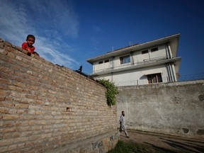 A boy looks over a wall in front of the compound where al-Qaida leader Osama bin Laden was killed in Abbottabad.  (REUTERS/Faisal Mahmood)