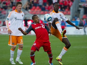 Toronto FC’s Joao Plata battles for the ball with Houston Dynamo’s Jevaughn Watson (right) and Bobby Boswell during their game on Saturday.  Plata scored in the game and was named MLS player of the week for his efforts.  (REUTERS)