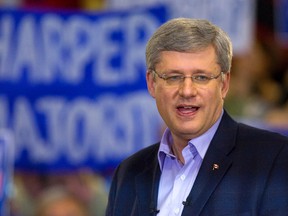 Prime Minister Stephen Harper addresses his supporters during an election rally. (MIKE HENSEN/QMI Agency Files)