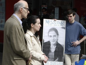 Vakhtang Makhniashvili, Lela Tabidze, and George Makhniashvili, right, show a poster of missing Mariam Makhniashvili during a small rally at Yonge St. and Dundas Square in April 2010.  (Toronto Sun file photo)