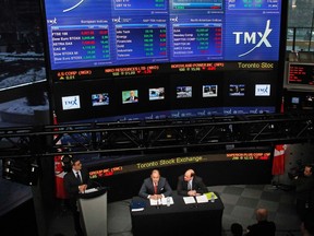 London Stock Exchange CEO Xavier Rolet (L) and TMX Group CEO Tom Kloet speak to the media in the TMX Broadcast centre in Toronto, Feb. 9, 2011.