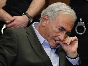 Former IMF chief Dominique Strauss-Kahn listens to his lawyer, William Taylor, inside of a New York State Supreme Courthouse during a bail hearing in New York May 19, 2011. (REUTERS/Richard Drew/Pool)