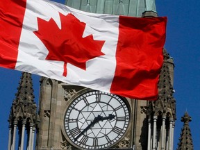 A Canadian flag waves in front of the Peace Tower, in Ottawa, March 24, 2011.      (Chris Roussakis/QMI Agency, file)