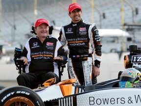Sam Schmidt Motorsports owner Sam Schmidt poses with Alex Tagliani by his Indy car during ceremonies honouring Tagliani’s achieving the pole position for Sunday's Indy 500. ( REUTERS/Geoff Miller )