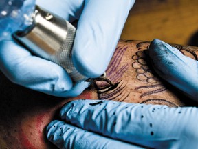 Tattoo artists in Grande Prairie, Alta., are upset about a bylaw requiring them to supply a blood test and criminal record check before the city will licence them or their businesses. (QMI Agency FILES)