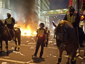 Mounted police and the riot squad maintain a street corner after a riot broke out in Vancouver, June 15, 2011. C(ARMINE MARINELLI/QMI AGENCY)