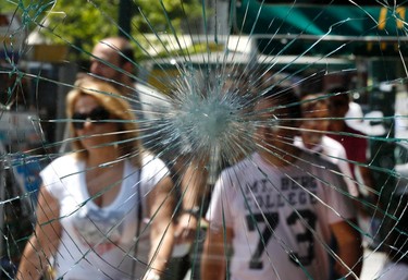 Tourists are seen through a cafe's smashed windows after Wednesday's riots in Athens' central Syntagma (Constitution) Square June 16, 2011. REUTERS/Yannis Behrakis