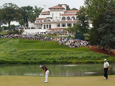 England's Luke Donald (left) putts on the 10th green as England's Lee Westwood (right) looks on during the first round of the 2011 U.S. Open at Congressional Country Club in Bethesda, Maryland, Thursday, June 16, 2011. (REUTERS/Kevin Lamarque)