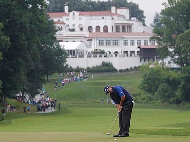 Argentina's Angel Cabrera putts on the 11th hole with the clubhouse in the background during the first round of the 2011 U.S. Open at Congressional Country Club in Bethesda, Maryland, Thursday, June 16, 2011. (REUTERS/Mathieu Belanger)