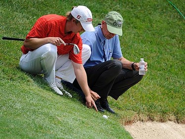 Amateur Brad Benjamin (left) of the U.S. gets a ruling from an official on the second hole during the first round of the 2011 U.S. Open at Congressional Country Club in Bethesda, Maryland, Thursday, June 16, 2011. (REUTERS/Jonathan Ernst)