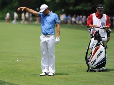Dustin Johnson of the U.S. takes a drop after hitting into a creek on the 11th hole during the first round of the 2011 U.S. Open at Congressional Country Club in Bethesda, Maryland, Thursday, June 16, 2011. (REUTERS/Jonathan Ernst)