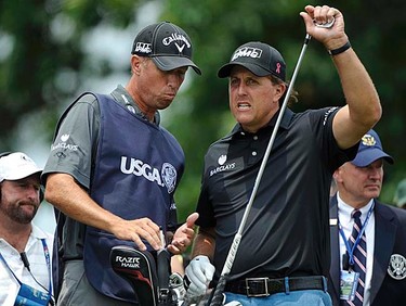 Phil Mickelson (right) of the U.S. speaks with his caddie, Jim Mackay on the 10th tee during the first round of the 2011 U.S. Open at Congressional Country Club in Bethesda, Maryland, Thursday, June 16, 2011. (REUTERS/Jonathan Ernst)