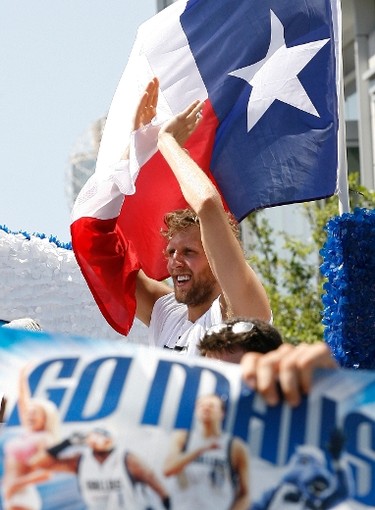 Dallas Mavericks forward Dirk Nowitzki rides on a float during a parade held to celebrate their NBA championship in Dallas, Texas June 16, 2011. Dallas defeated the Miami Heat to win the 2011 NBA title. (REUTERS)