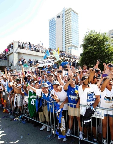 Fans line the street and cheer as the Dallas Mavericks are honored with a parade to celebrate their NBA championship in Dallas, Texas June 16, 2011.  Dallas defeated the Miami Heat to win the 2011 NBA title. (REUTERS)