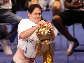 Dallas Mavericks owner Mark Cuban polishes the championship trophy during a event held to celebrate their NBA championship in Dallas, Texas June 16, 2011.  Dallas defeated the Miami Heat to win the 2011 NBA title. (REUTERS)