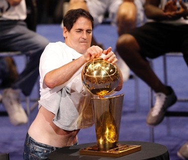 Dallas Mavericks owner Mark Cuban polishes the championship trophy during a event held to celebrate their NBA championship in Dallas, Texas June 16, 2011.  Dallas defeated the Miami Heat to win the 2011 NBA title. (REUTERS)