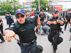 In this 2010 G20 file photo, police and protesters clash near the detention centre on Eastern Ave. (CRAIG ROBERTSON/Toronto Sun/QMI Agency)