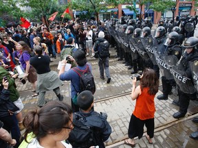 In this 2010 G20 file photo, protesters march at Spadina Ave. and Richmond St. W. where they met the riot squad. (MICHAEL PEAKE/Toronto Sun)