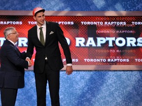 Jonas Valanciunas shakes hands with NBA commissioner David Stern after the Raptors selected the 6-foot-11 Lithuanian in the first round of the draft Thursday night in New Jersey. (REUTERS)