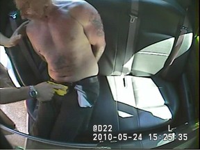 A frame grab from a police cruiser video shows Const. Christopher Hominuk threatening to Robert Bolgan in the crotch.