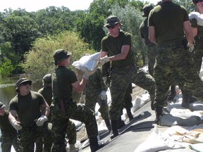 Soldiers based out of Shilo build up dikes around Souris in anticipation of a crest to come early next week. An additional 175 soldiers joined the 200 already in Souris. (Photo courtesy Government of Manitoba)