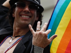 Manuel Rojas shows off his engagement ring during the Gay Pride Parade in New York June 26, 2011. REUTERS/Jessica Rinaldi