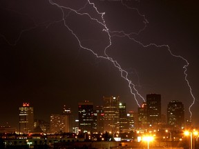 Lightning strikes behind the city skyline. (EDMONTON SUN FILE)