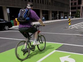 The dedicated bike lanes opened on Laurier Avenue in Ottawa on Sunday July 10,2011. (ERROL MCGIHON/THE OTTAWA SUN/QMI AGENCY)
