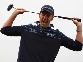 Henrik Stenson of Sweden reacts after missing his birdie putt on the 17th green during the first round of the British Open at Royal St. George's in Sandwich, England on July 14, 2011.   (REUTERS/Eddie Keogh)