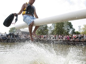 An Islendingadunk combatant puts his opponent in Gimli Harbour during the 2010 Icelandic Festival, held over the August long weekend. (MARCEL CRETAIN/Winnipeg Sun)