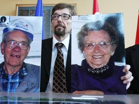 Bret McCann holds photos of his parents, Lyle McCann (left) and Marie McCann in this July 13, 2010, photo. (EDMONTON SUN FILE)