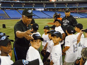 Sandy Alomar Sr. talked to kids wth his son Roberto during the Jays Care Foundation on-field instructional clinic at the Rogers Centre in Toronto on July 29, 2011. (MICHAEL PEAKE/Toronto Sun/QMI Agency)