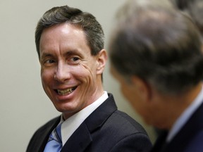 Warren Jeffs (L) smiles at defence attorney Richard Wright, prior to closing arguments in Jeffs' trial in St. George, Utah, in this Sept. 21, 2007 file photograph. REUTERS/Doug Pizac/Files