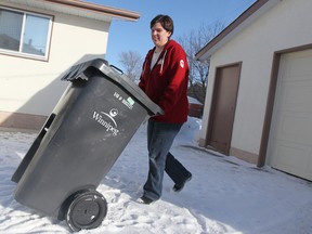 Teri-Lyn Skakum shows off her garbage cart back in March 2011. A city master plan for waste pick-up once included a pilot project for compost, but the city never went through with it. Now administration is trying to push a plan with a pricey fee attached. (Winnipeg Sun files)