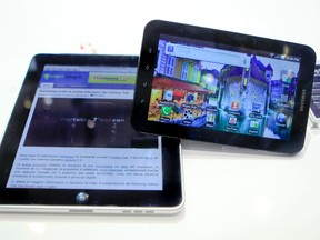 File photo of an Apple iPad (L) next to Samsung's Galaxy Tab tablet devices at the Internationale Funkausstellung (IFA) consumer electronics fair at "Messe Berlin" exhibition centre in Berlin, Sept. 2, 2010.     REUTERS/Thomas Peter/Files