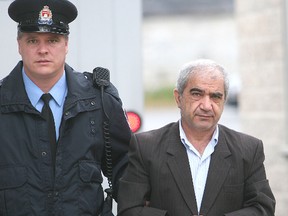 Mohammad Shafia is brought into Frontenac County Courthouse. (MICHAEL LEA/QMI AGENCY FILE PHOTO)