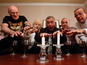 Elvis sighters, from left, Bob Prieur, Lorraine Prieur, the late Earl McRae, Moe Atallah and Ervin Budge, hold a seance in Capital Hill Suites room 711 where Elvis is believed to have stayed during his one-time Ottawa concert. A special Elvis trivia charity night is being held May 3 in honour of McRae.
(DARREN BROWN/Ottawa Sun file photo)
