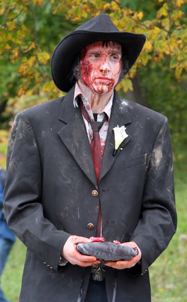 The Best man holds the wedding rings at the wedding of Thea Munster and Adam Invader. The event was held before the 9th Annual Zombie Walk in Toronto on Oct. 22, 2011. (VERONICA HENRI/Toronto Sun/QMI Agency)