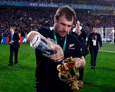 New Zealand's Andrew Hore pours wine into the Webb Ellis Cup as he celebrates beating France to win the Rugby World Cup final match at Eden Park in Auckland on Oct. 23, 2011. (REUTERS)