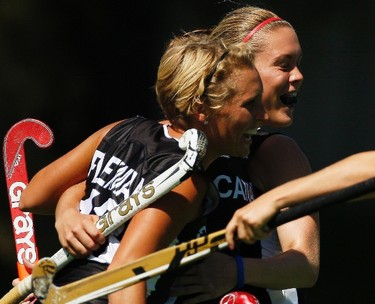 Canada's Tyla Flexman (L) celebrates with teammate Brienne Stairs after scoring a goal against Trinidad and Tobago during their Group A women's field hockey match at the Pan American Games in Mexico on Oct. 23, 2011. (REUTERS)