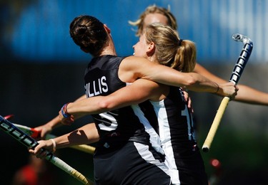 Canada's Katherine Gillis (L) celebrates with teammate Abigail Raye (R) after scoring a goal against Trinidad and Tobago during their Group A women's field hockey match aat the Pan American Games in Mexico on Oct. 23, 2011. (REUTERS)